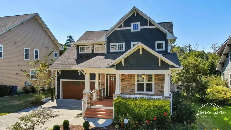 Two-story craftsman home with a covered front porch and an attached garage