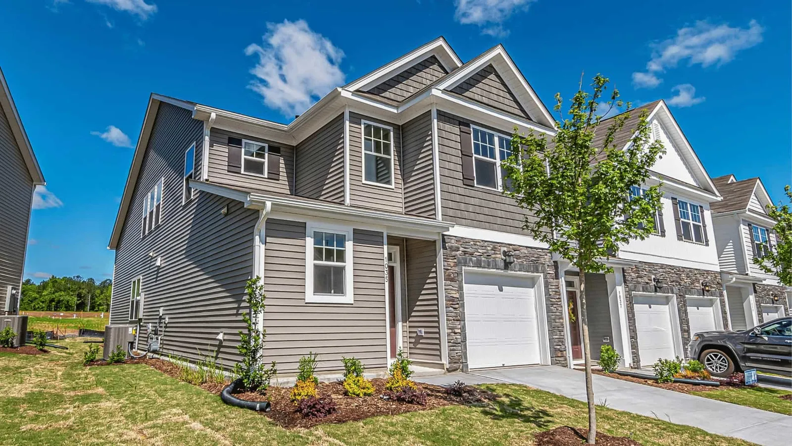 Row of two-story townhomes with attached garages