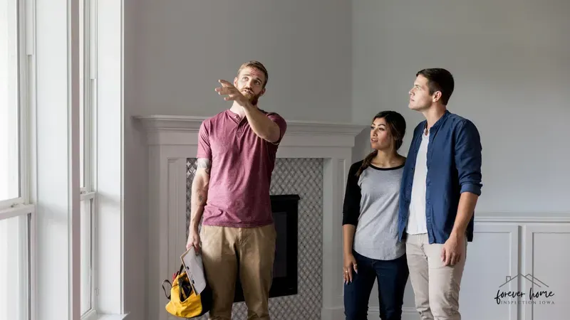Inspector pointing out a detail to a couple in a home's living room