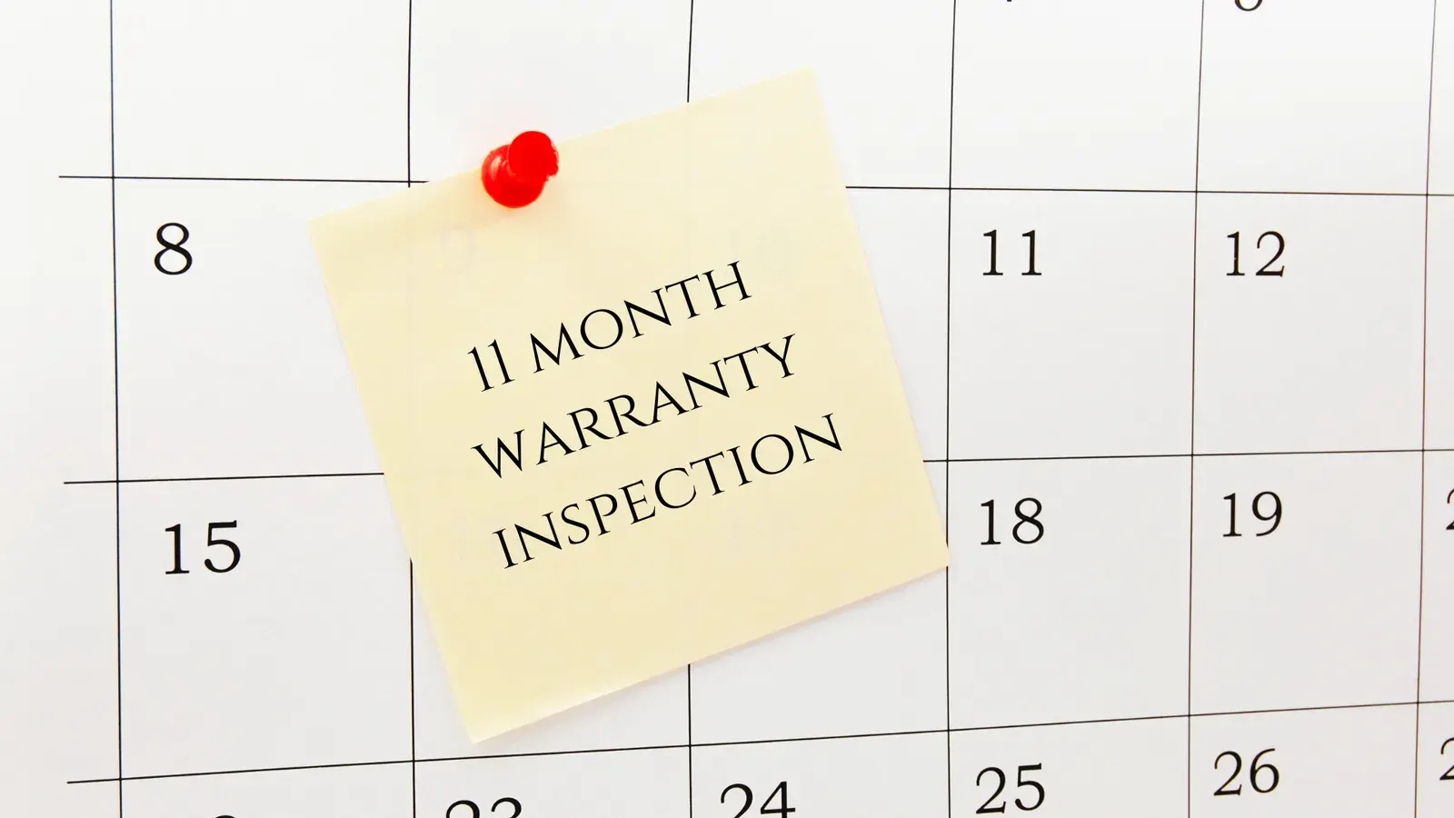 Calendar with a sticky note that says 11 Month Warranty Inspection
