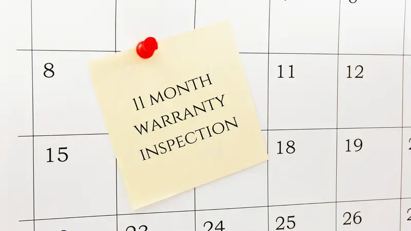 Calendar with a sticky note that says 11 Month Warranty Inspection
