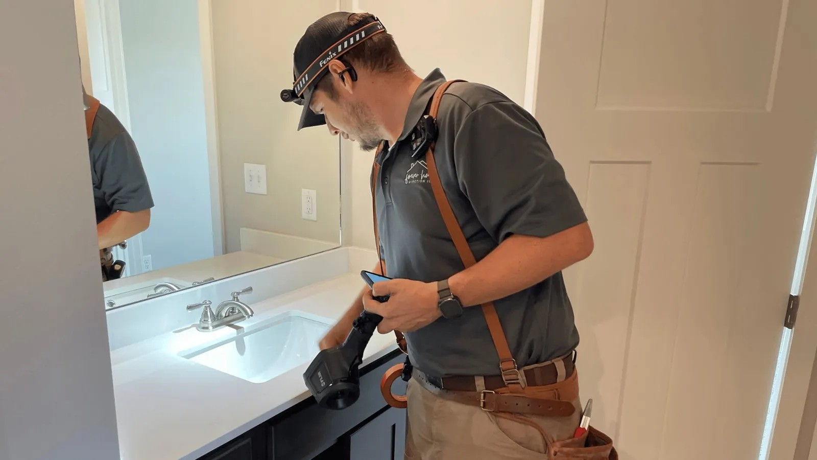 Inspector checking a bathroom vanity and sink