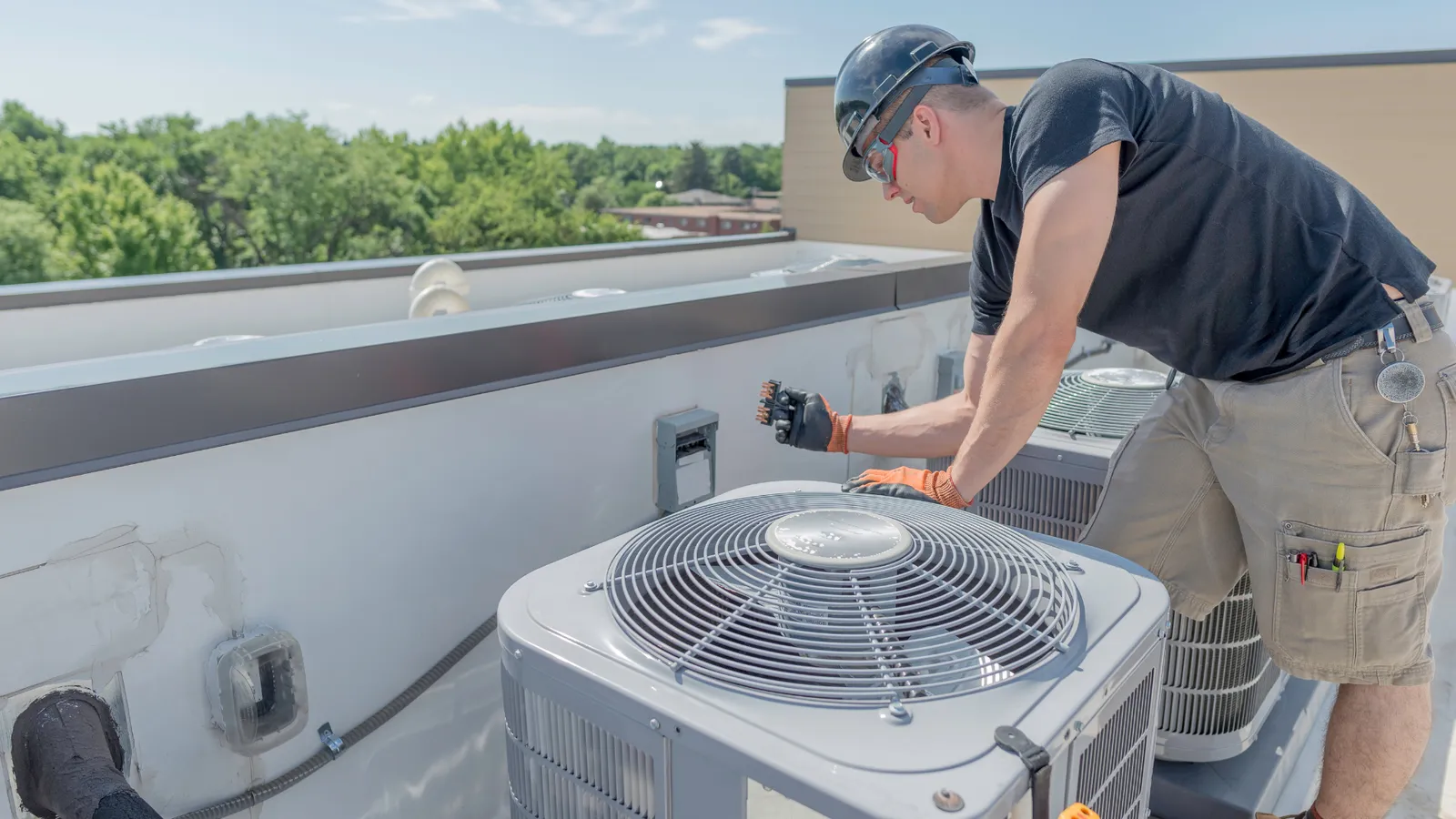 Technician servicing an outdoor air conditioning unit