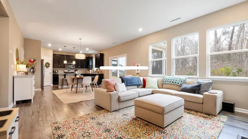 Open living room and kitchen with large windows