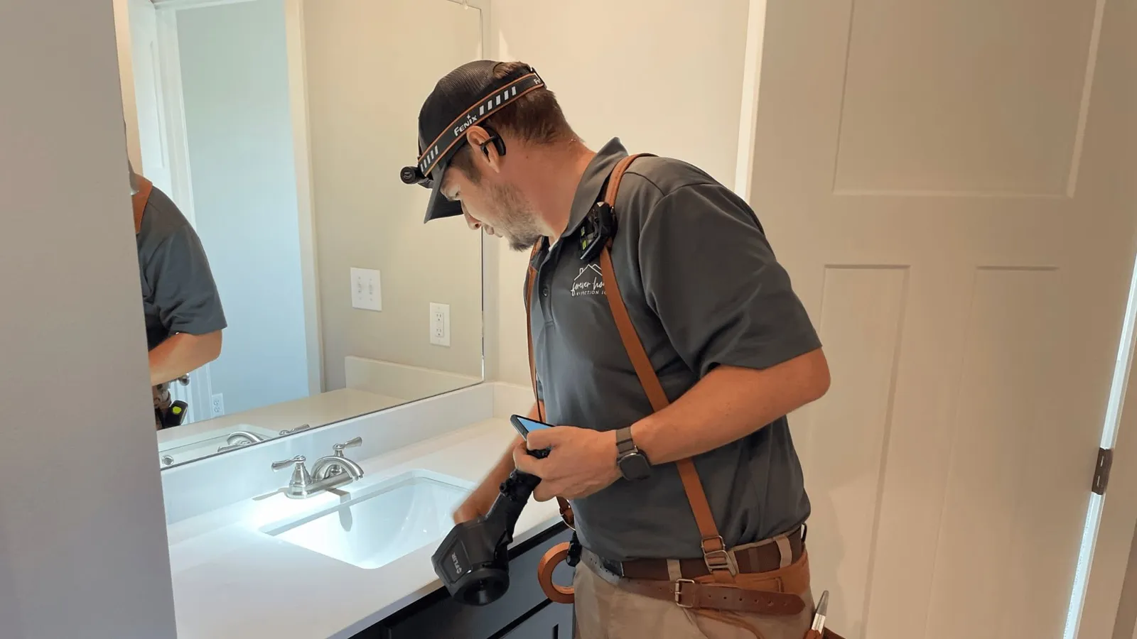 Inspector checking a bathroom vanity and sink