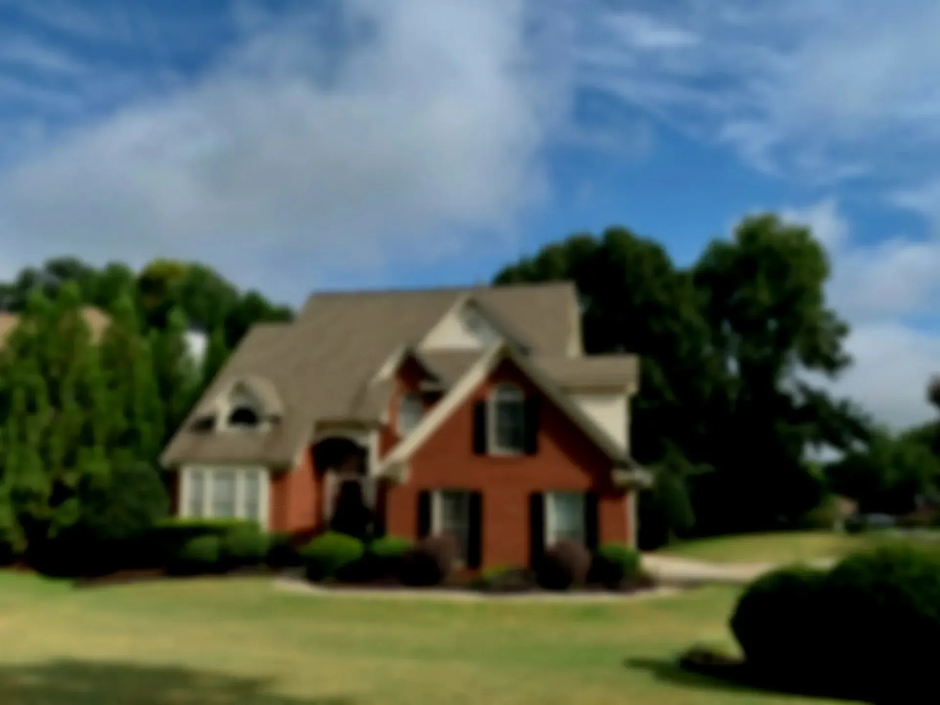 Brick-and-siding two-story home with a big green lawn