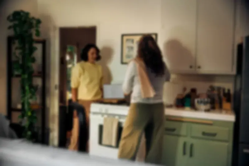 Couple standing together in a warm, welcoming kitchen