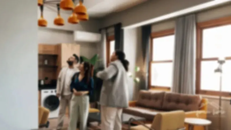 Three people touring the living room of a home