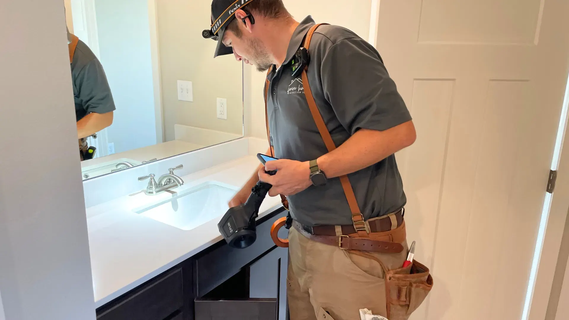 Matt Gibson inspecting a bathroom vanity during a buyer home inspection
