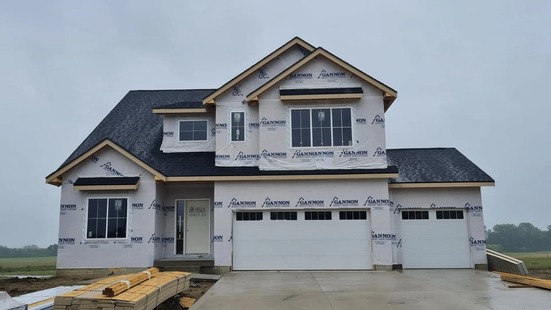 Two-story new construction home covered in house wrap