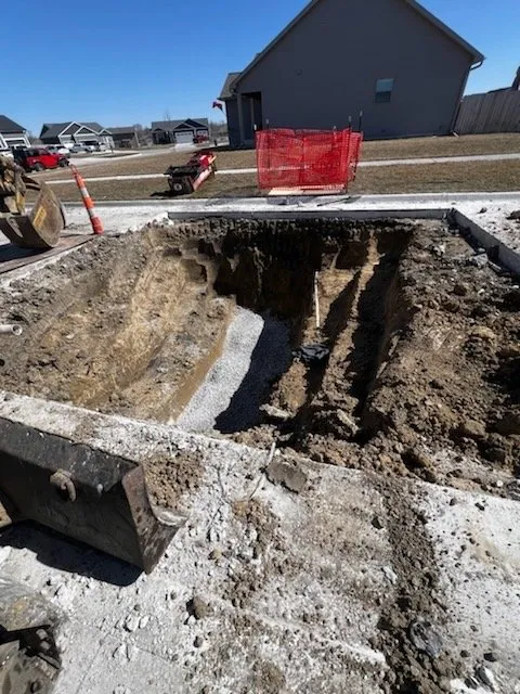 A street dug open to reach and replace a broken sewer lateral