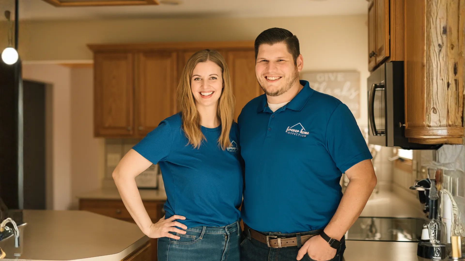 Matt and Kalyn Gibson, owners of Forever Home Inspection Iowa, standing in a kitchen