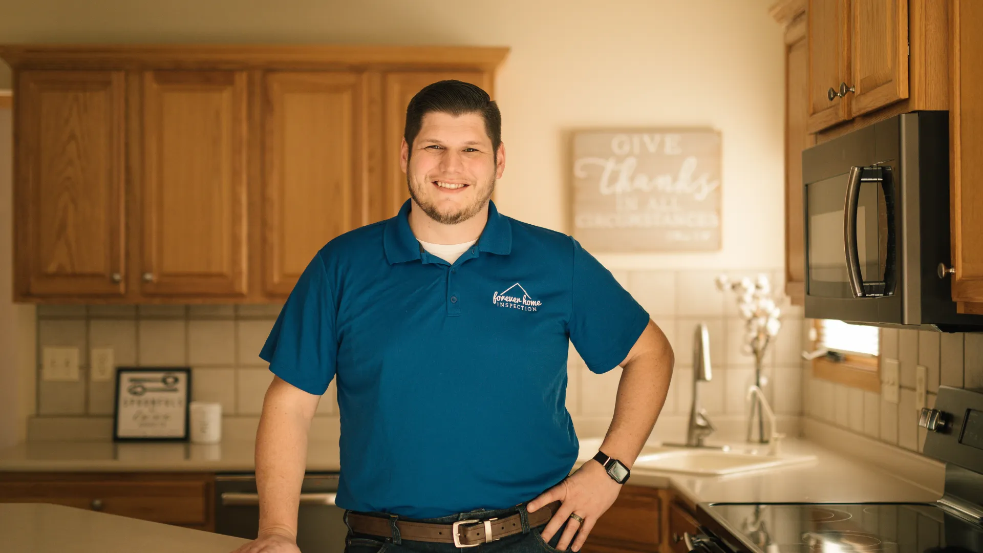 Matt Gibson in a blue company polo standing in a kitchen